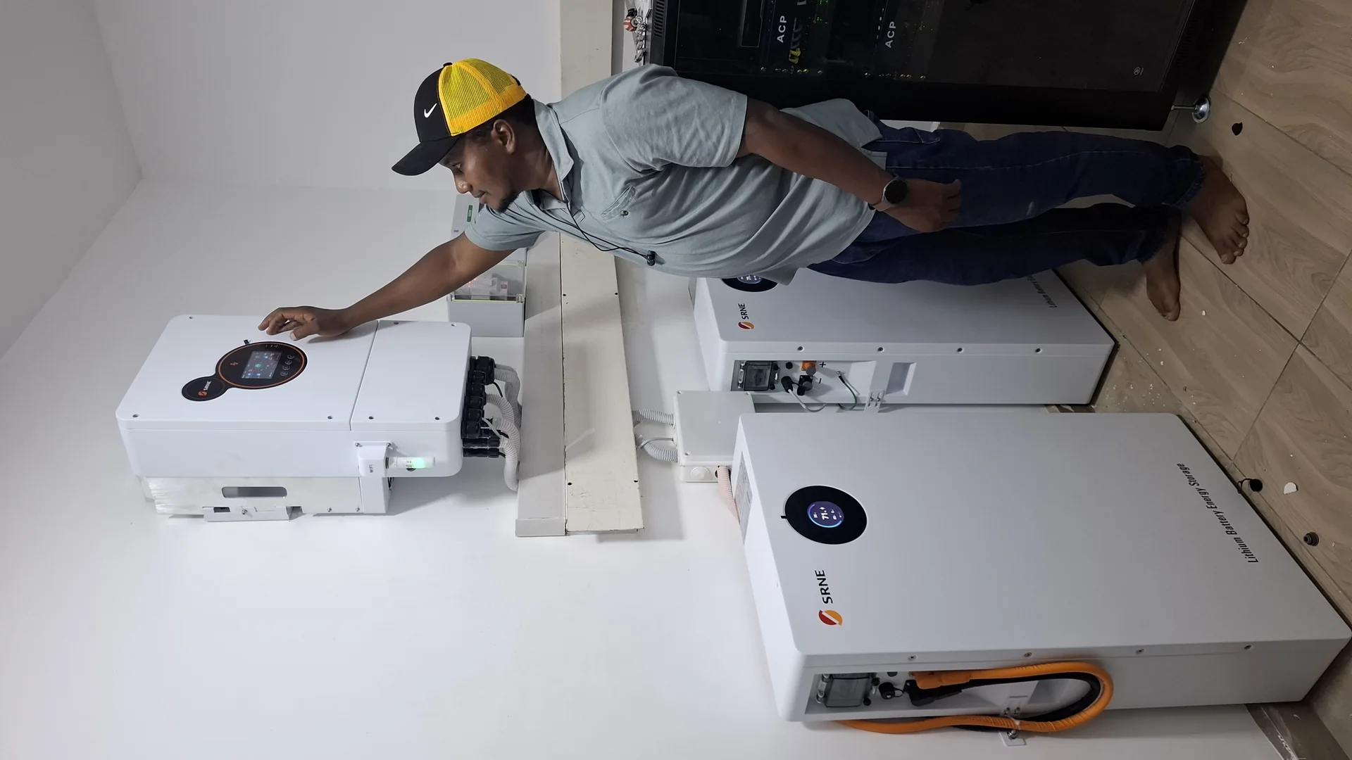 Solar technician working on a rooftop panel installation